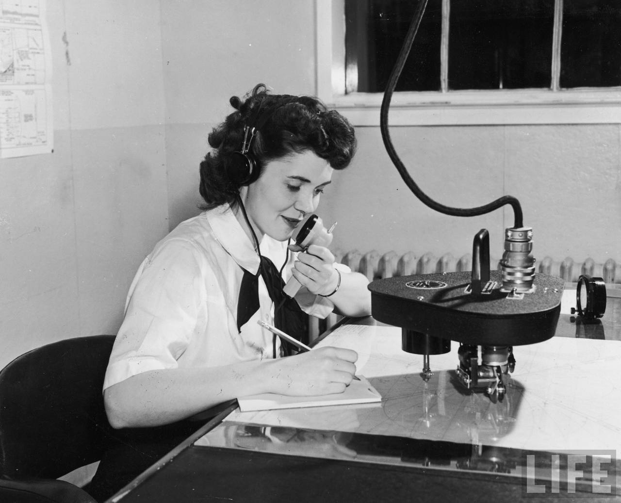 Woman talking into a writing machine